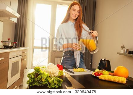 Beautiful Redhaired Ginger Woman Making Fruits Smoothies With Blender, Preparing Drink With Bananas,