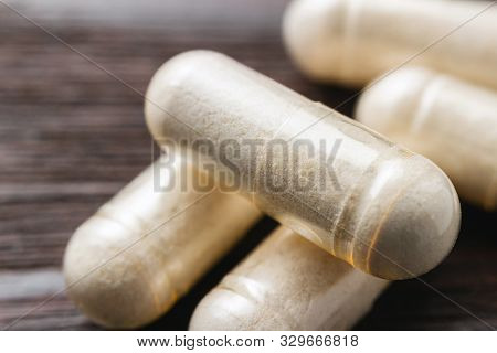 White Medical Capsules Of Glucosamine Chondroitin, Healthy Supplement Pills On Wooden Background, Ma