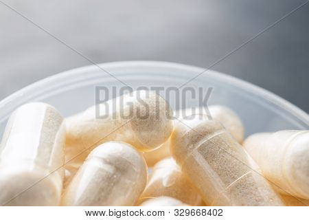 White Medical Capsules Of Glucosamine Chondroitin, Healthy Supplement Pills In The Plastic Spoon On 