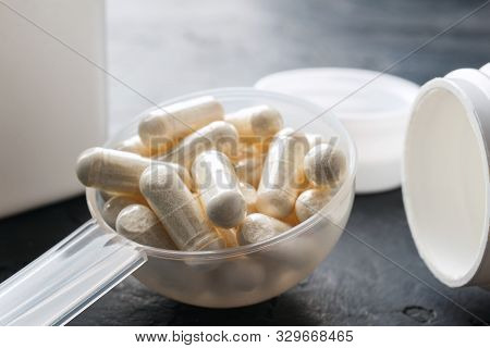 White Medical Capsules Of Glucosamine Chondroitin, Healthy Supplement Pills In The Plastic Spoon On 