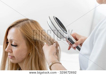 Dnipro / Ukraine - 04.27.2019: A Trichologist Examines The Condition Of The Hair On The Patients Hea