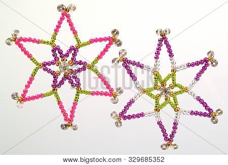 A Picture Of Two Colourful Beaded Wire Stars Christmas Tree Decorations