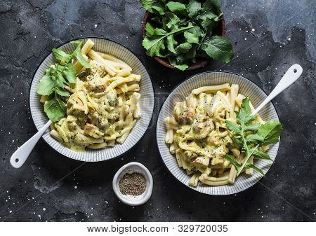 Curried Creamy Salmon With Pasta On A Dark Background, Top View