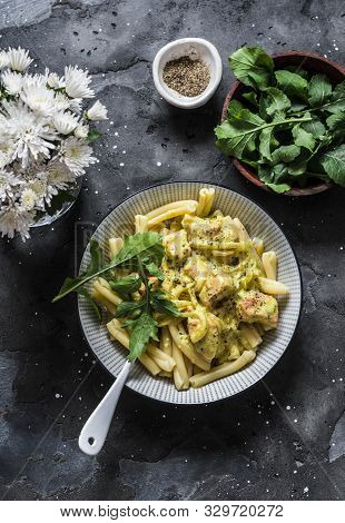 Curried Creamy Salmon With Pasta On A Dark Background, Top View