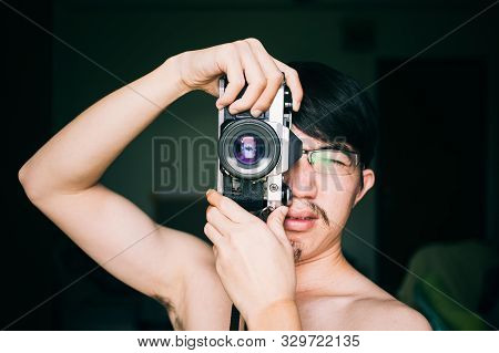 Close Up Man Taking Photos With An Old Vintage Film Camera