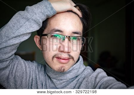 Portrait of Asian man setting his hair
