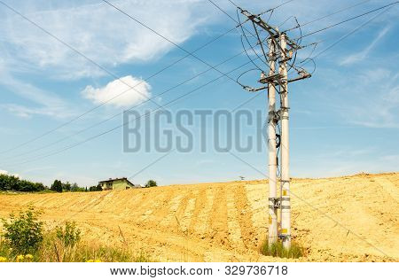 Igh-voltage Power Lines On  Field Against With Blue Sky