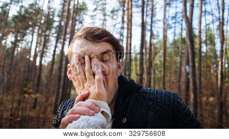 A Womans Hand Hits A Mans Face In The Autumn Forest. An Emotional Male Is Getting Slapped In Face, W