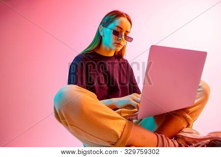 Modern Girl With Laptop, Tablet Computer. Free Creativity. A Young Blogger Makes A Home Office. Colo