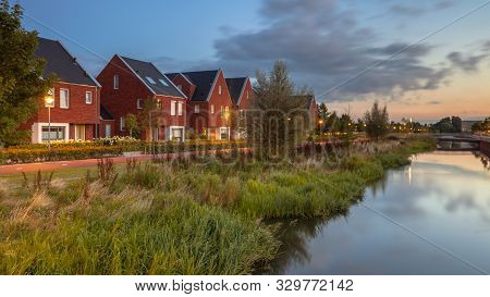 Long Exposure Night Image Of Suburban Street With Modern Ecological Family Houses With Eco Friendly 