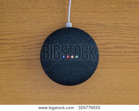 Smart Home Voice Activated Speaker On Wooden Desk Table From Above