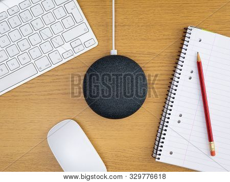 Smart Home Device Speaker With Mouse And Keyboard On Wooden Table Desk