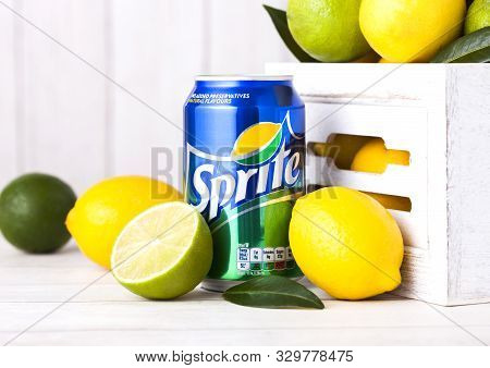 London, Uk - April 12, 2017: Aluminium Can Of Sprite Drink On Wooden Background With Lemons And Lime