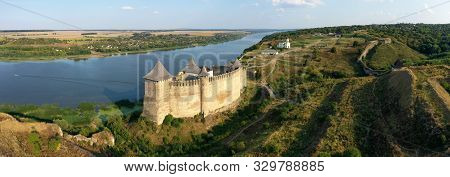 Aerial View Of Old Castle Near The River. Hotyn Castle In Ukraine. Eastern Europe
