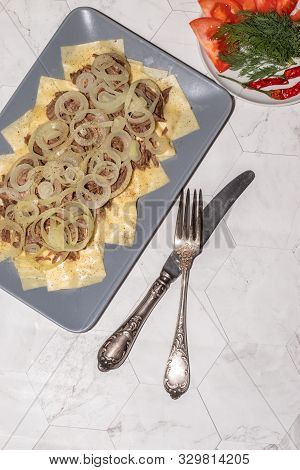 Beshbarmak Is A National Tatar Dish - Square Pasta With Boiled Meat And Onions. On A Light Backgroun