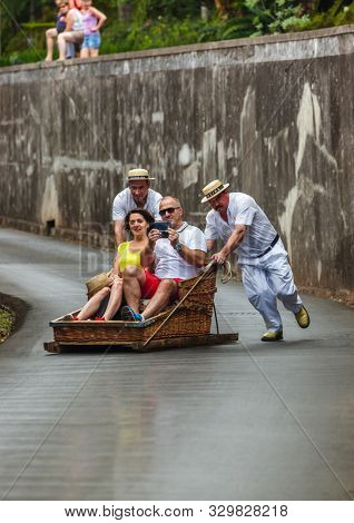 FUNCHAL, MADEIRA - SEPTEMBER 19: Traditional downhill sledge trip on September 19, 2016 in Madeira, Portugal.