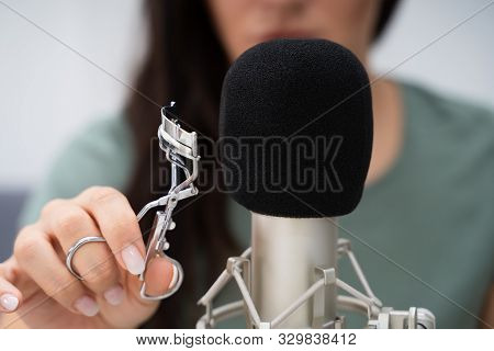 Woman Using Eyelash Curler On Microphone To Make Asmr Sounds