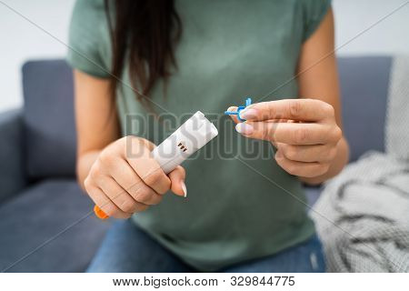 Woman Using Auto-injector Syringe As An Emergency Treatment For Allergic Reaction