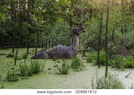 Belgorod, Russia - May 31, 2019: Full-size Iguanodon Statue In The Swamp Of Belgorod Dinopark.