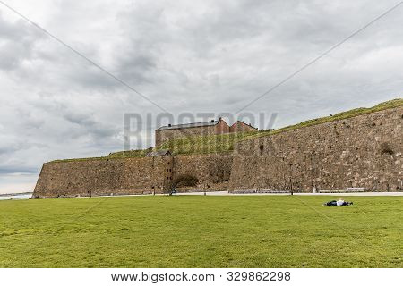 The Fortress Of Varberg Is An Old Fortification, Built In 1287-1300. A Boy And A Girl Are Resting On