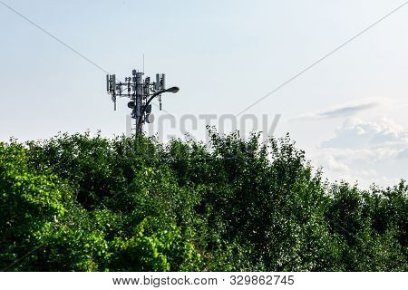 A Closeup View On The Top Part Of A 3g, 4g And 5g Mobile Communications Cell Tower With Antenna Tran