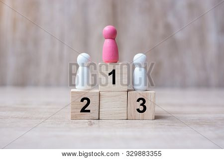 Pink Laday Wonan Wooden Stand On A Top Of State Or The Winner. People, Business, Successful And Vict