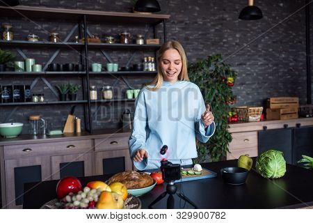 Young Beautiful Blonde Takes On Videos As She Cooks In The Kitchen
