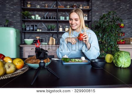 Young Beautiful Blonde Takes On Videos As She Cooks In The Kitchen