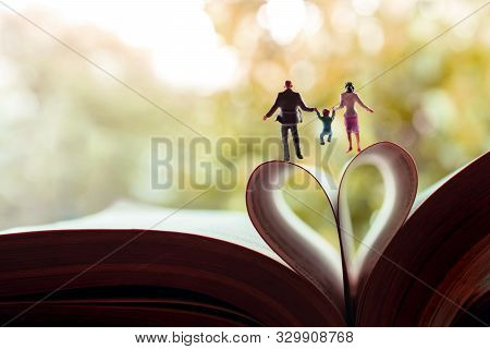 Love And Happy Family. Work Life Balance Concept. Miniature Of Father, Mother And Son Holding Hands 