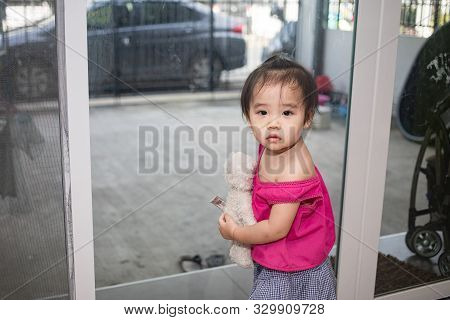 Little Adorable Girl Sitting And Playing In Living Room