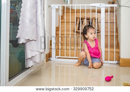 Little Adorable Girl Sitting And Playing In Living Room