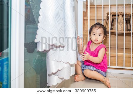 Little Adorable Girl Sitting And Playing In Living Room