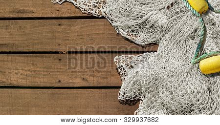 Fishing Net On Wooden Decking Background With Copy Space