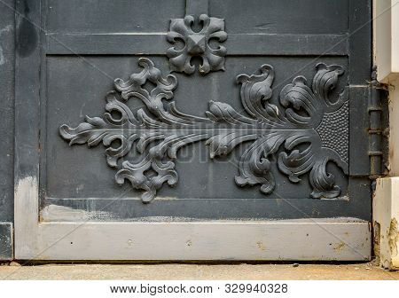 Close-up Of Detail Of Ancient Vintage Metal Door With Cast Iron Floral Deorative Ornament
