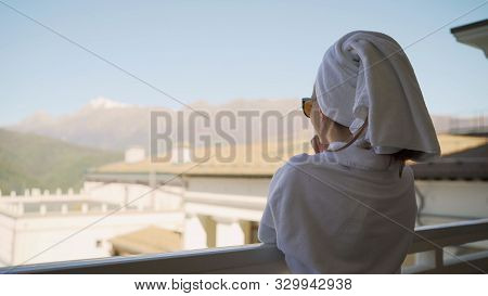 A Girl In A White Robe Stands On The Balcony And Enjoys. Sexy Girl In White Robe Stands On The Balco