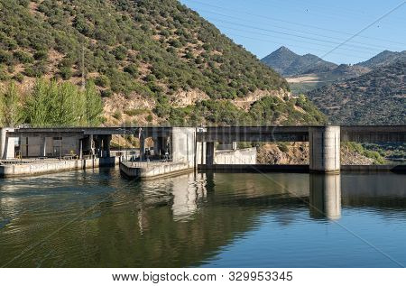 Solid Structure Of The Valeira Dam On River Dourowith Lock And Gates On The Left