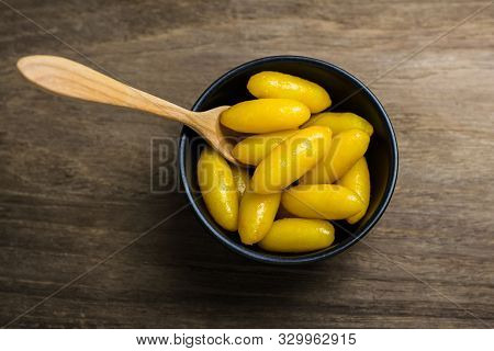 Thai Traditional Desserts Mung Bean Paste Formed In Egg Yolk And Sugar In Black Small Bowl On The Wo