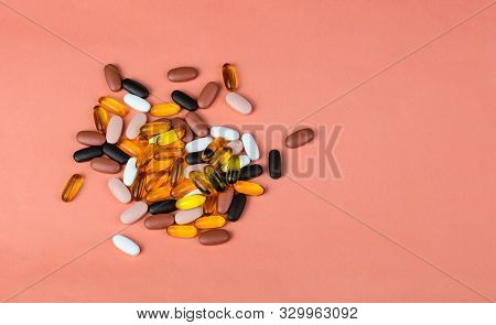 Fishoil Capsules And Multivitamin Supplements On The Pink Background With Copy Space.