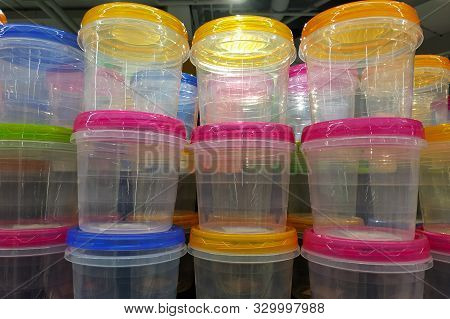 Transparent Plastic Food Containers With Multi-colored Lids Stacked In A Stack. Plastic Containers F