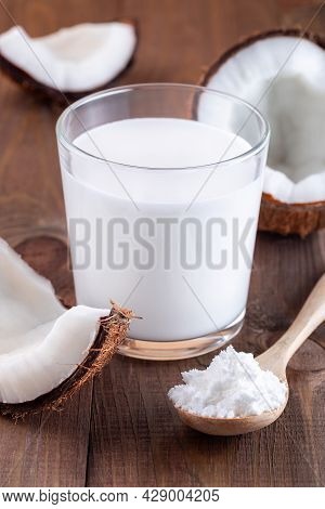 Coconut Milk In Powder And Dissolved With Water In A Glass, Lactose Free Milk On A Wooden Background