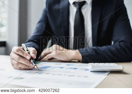 Businessman Sits In A Private Office At His Company And Is Reviewing Company Financial Documents, Se