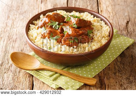 Pork Afelia Stewed With Red Wine And Served With Bulgur Close-up In A Bowl On The Table. Horizontal