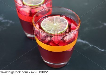 Closeup Two Glasses Of Chilled Red Wine Sangria Isolated On Black Table