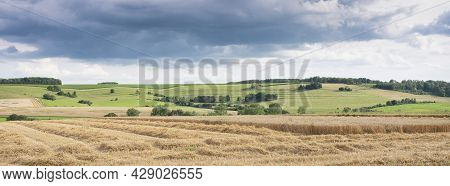 Cloudy Sky Over Summer Countryside Landscape With Green Meadows And Corn Fields In French Ardennes N