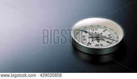 Compass On Black Board Background And A Lot Of Copy Space. Concept - Compass Showing The Right Direc