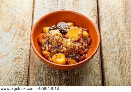 Jewish Dish Chelnt With Meat On A Wooden Table In A Plate. Copy Space Horizontal Photo