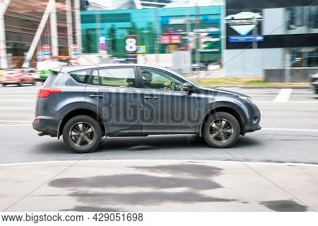 Fast Moving Gray Toyota Rav4 Suv Rides On A City Road. A Car On Street In Motion. Overspeed In City 
