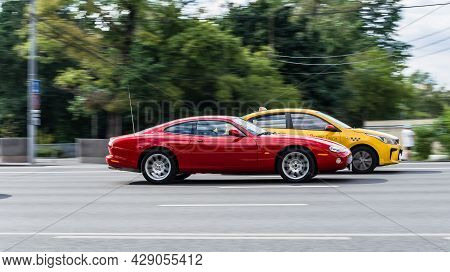 Red Jaguar Xk8 Coupe Rides On Street On High Speed. Jaguar Xkr Model Is The First Generation Of A Ne