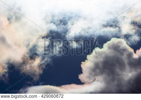 White Beautiful Clouds With Iridescence Against The Blue Sky