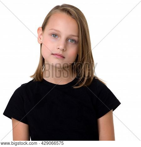 Pretty Blonde In A Black T-shirt. Girl In Fashionable Clothes Posing In The Studio. Close Up Portrai